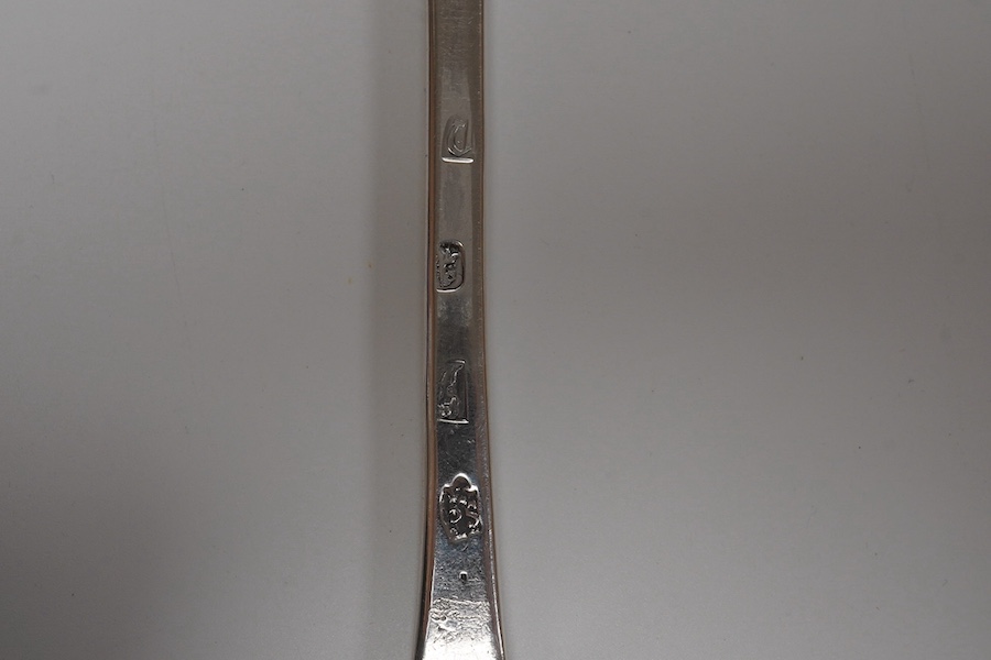 A Queen Anne silver dog nose basting spoon, with rat tail bowl, by William Scarlett, with engraved dated armorial to the terminal, London 1708, 32cm length, 95g. Condition - poor to fair